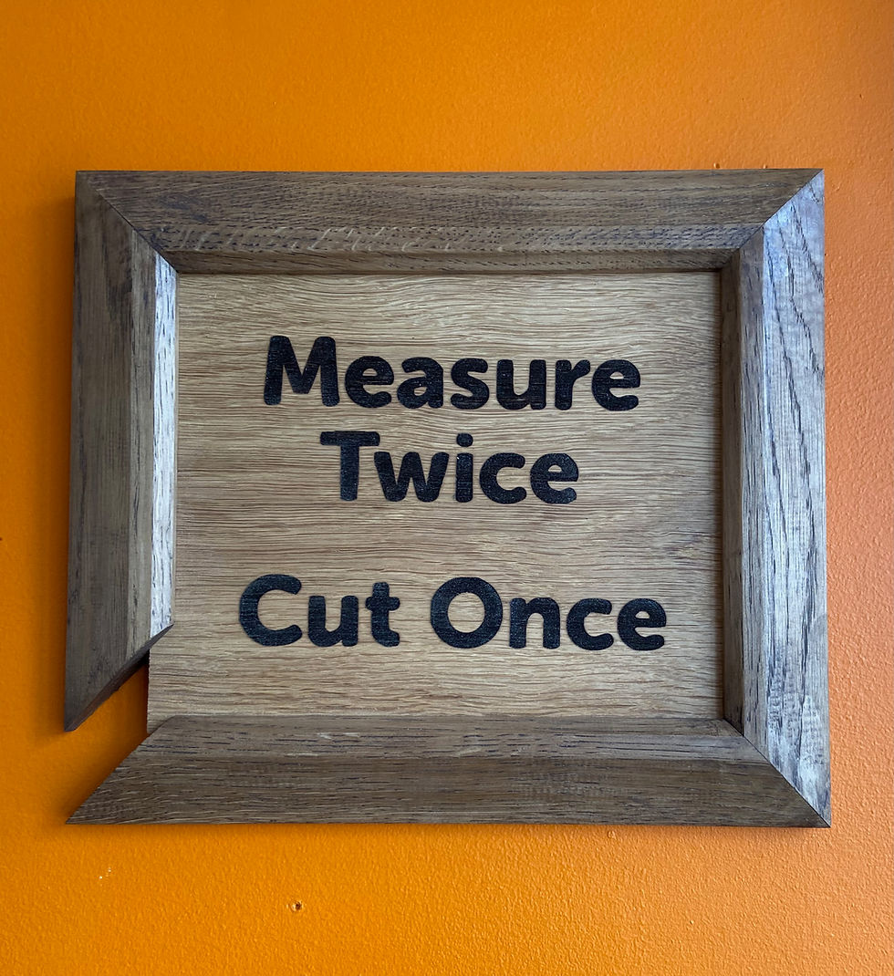 Measure Twice, Cut Once art piece on the wall at The Joinery Cafe