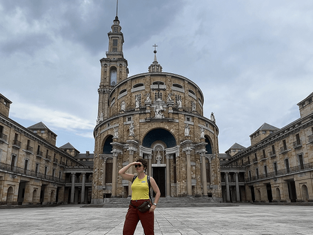 Woman standing in front of the cathedral in Oviedo, Spain