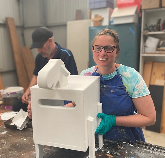 Young woman building a letter box in workroom
