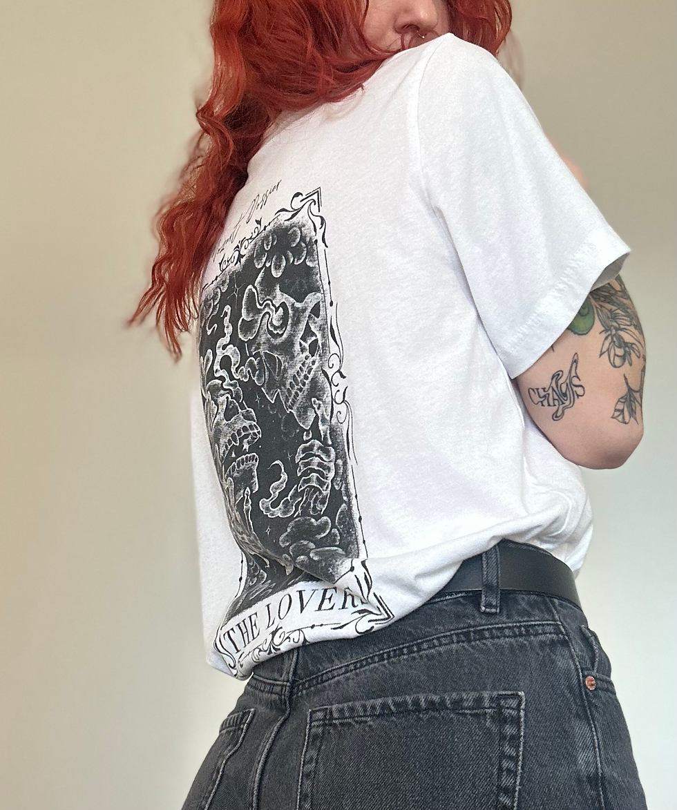 Posed image of "THE LOVERS" T-shirt, showing the back design while styled in outfit. looks sick af :)