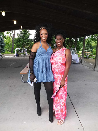 anjuli with her oldest sister. anjuli wears a blue dress while her sister wears a pink one.