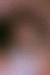 a cheeky photo of anjuli, draped in a blanket, her kinky straight extensions tousled and covering her from being exposed.