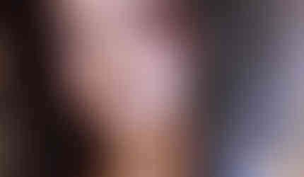 a sultry portrait of Anjuli.she wears a smokey brown eyeshadow with black liner and a bleached blonde eyebrow. her look is paired with a pink blush and MAC nude lipstick in Fleshpot.