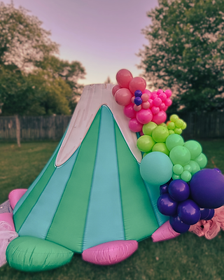 Artistic inflatable dragon decoration in a garden setting by One Two Celebrate