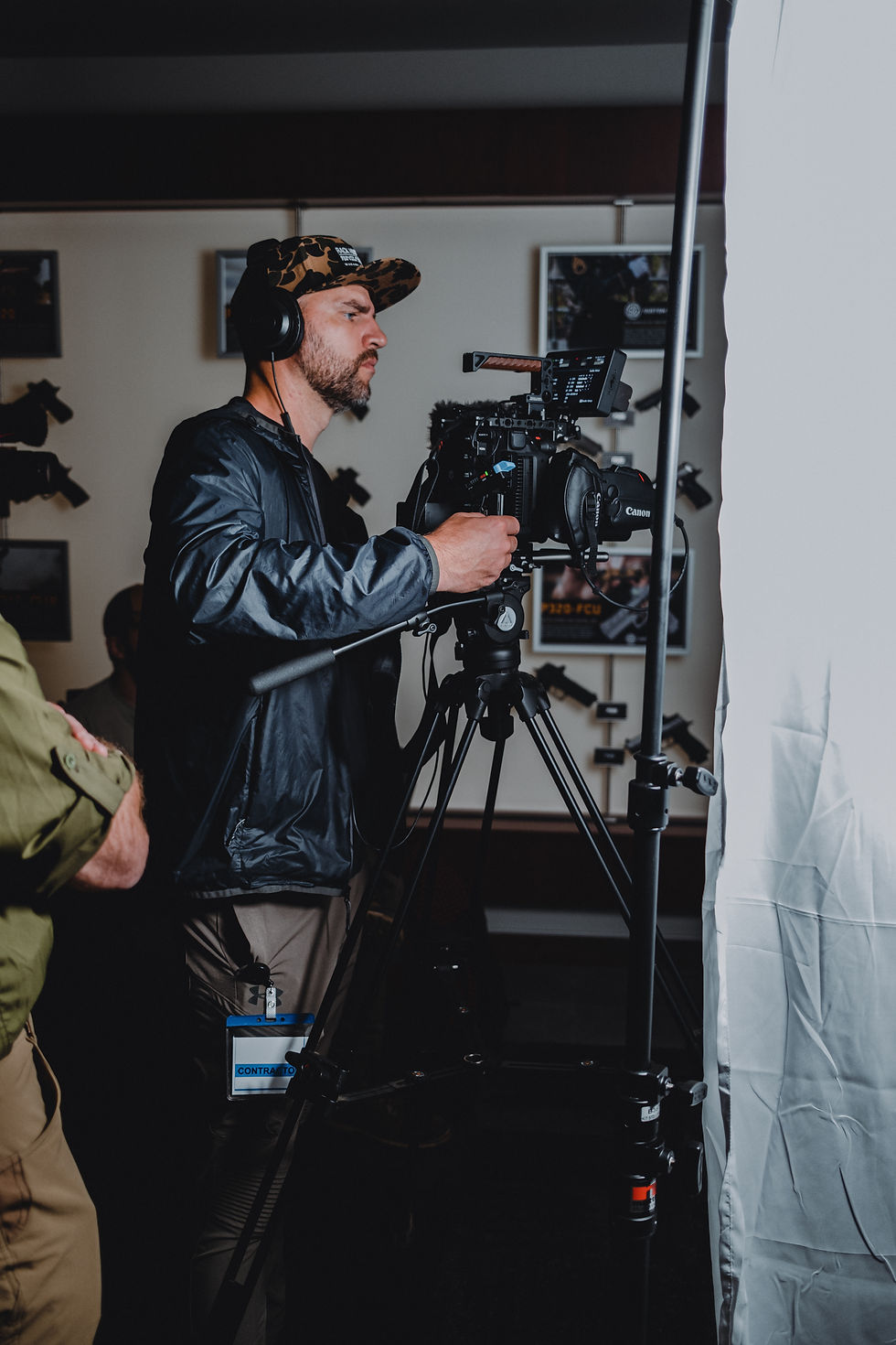 cameraman on set with cinema camera and soft lighting