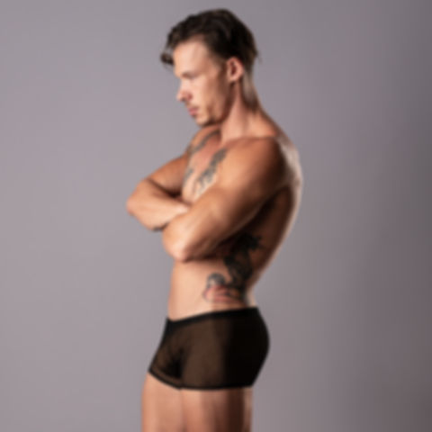 Man wearing black fishnet shorts