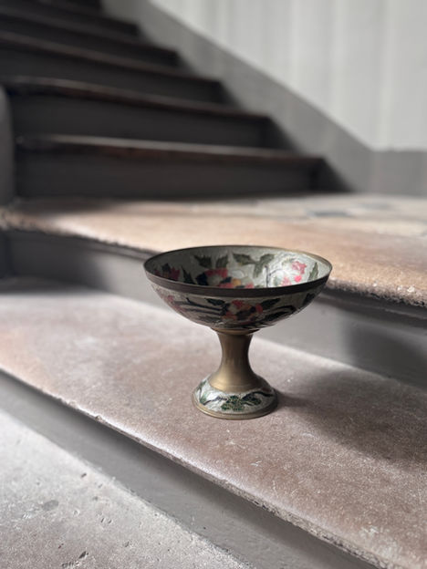 Hand-painted floral pedestal bowl with decorative metallic accents.