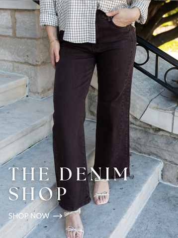 Model wearing dark-wash wide-leg jeans with a raw hem and heeled sandals, showcasing women's denim styles from Hollie Ray Boutique.