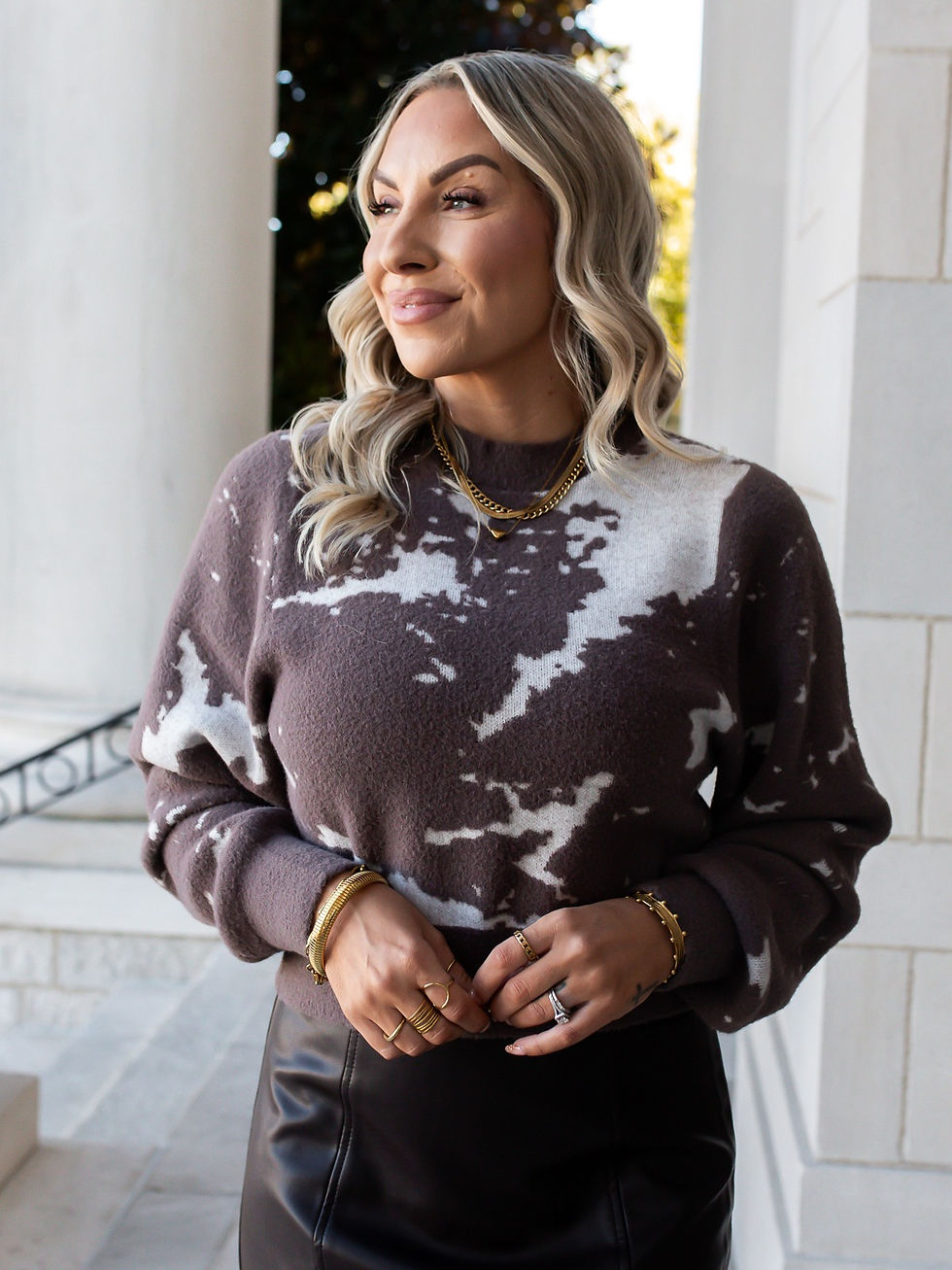 Woman wearing Carrara taupe abstract knit sweater, front view