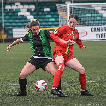 Dani Mawle battles for the ball against the Felinheli attacker. Credit: Steve Williams Photography