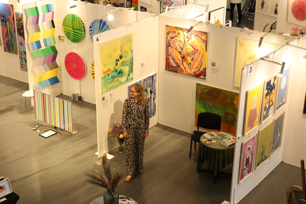 The artist in the exhibition heart - surrounded by her beautiful artworks
