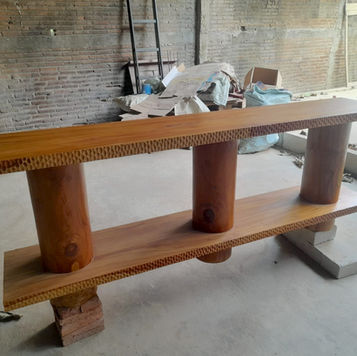 Solid teak console table featuring thick round wood pillar legs and hand carved textured edge detail