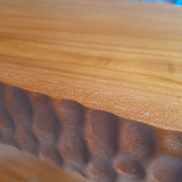 Sculptural solid teak console table with chunky cylindrical wood legs and natural grain finish