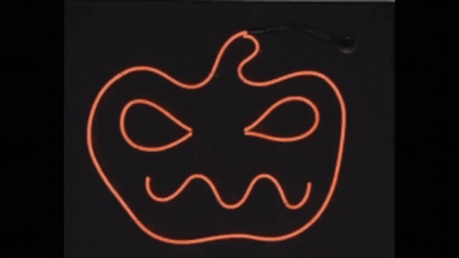 Blinking neon line art jack-o’-lantern design on black canvas STEM kit