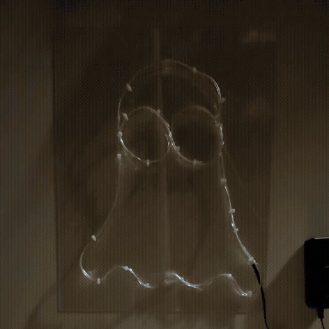 Neon line art ghost design on acrylic sheet with blinking light effect