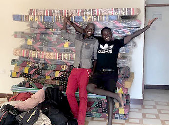 Muko and Juma with mattresses.