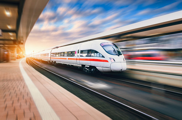 White modern high speed train in motion on railway station at sunset. ICE Germany