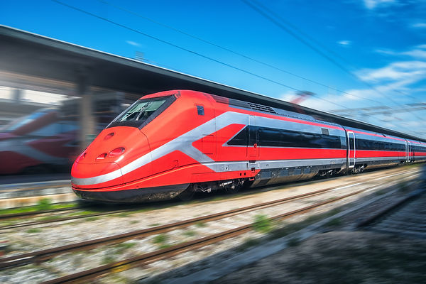 Red high speed train in motion on the railway station. Fast moving FrecciaRossa - Italy