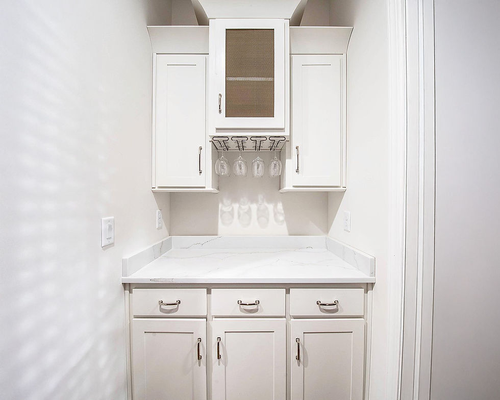 Custom built-in wine storage cabinet with glass rack and shaker doors, designed for home entertaining.