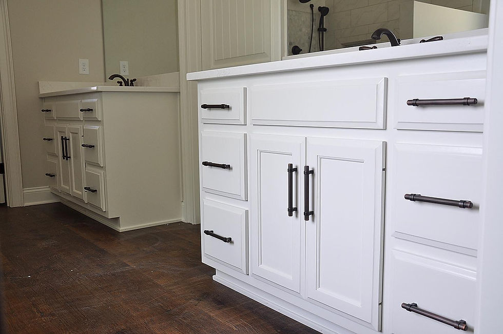 Custom white double bathroom vanity with shaker-style cabinets and dark hardware by Hartsville Cabinet & Millwork.