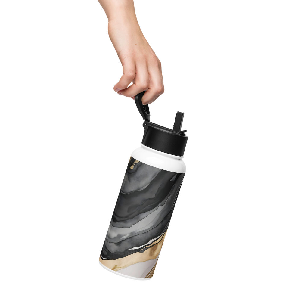 Reusable stainless steel water bottle with gold marble design reversed and in hand