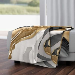 Eclipse Veins Luxe Marble throw blanket draped across bed in modern bedroom.