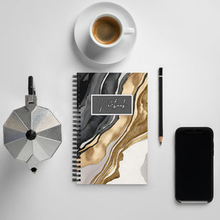 Hand holding luxe marble spiral notebook outdoors