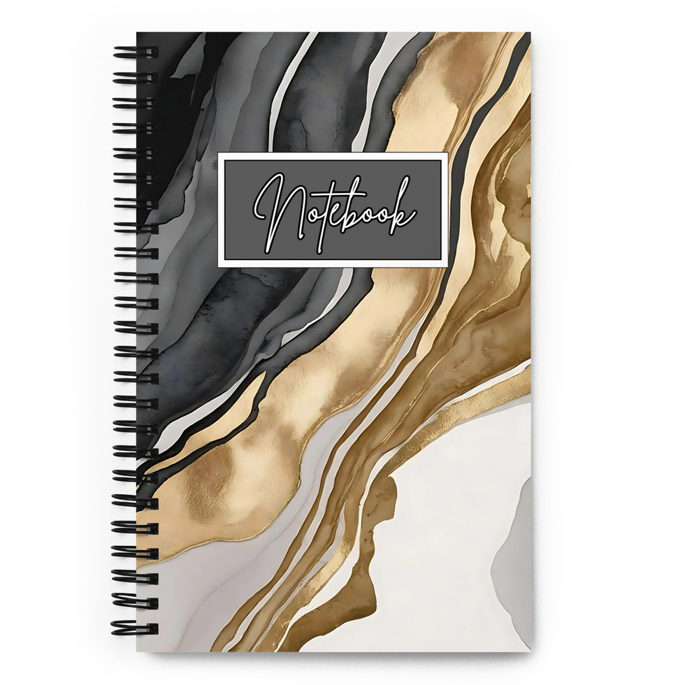 Spiral notebook with gold, black, and marble cover on minimalist desk setup