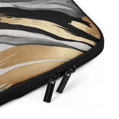 Overhead view of laptop sleeve with zipper and abstract pattern in focus.