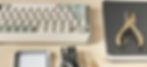 A keyboard, phone case, and stationary sit on a marketing writer's desk.