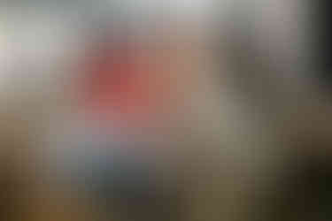 A lively group of young coworkers enjoys Christmas cheer while playing together at work.