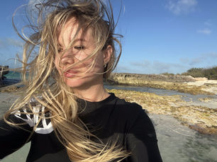 Productivity boost from a change of environment: Designer enjoying creative space by the beach for fresh ideas.