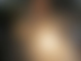 Designer seated at a table, resting her chin on her hand, reflecting on the creative process and the early, uncertain stages of design work.