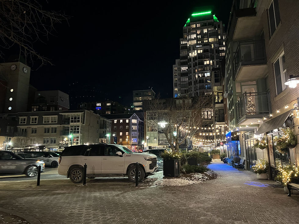 Winter evening city street with warm lights, modern buildings, and a calm New Year atmosphere