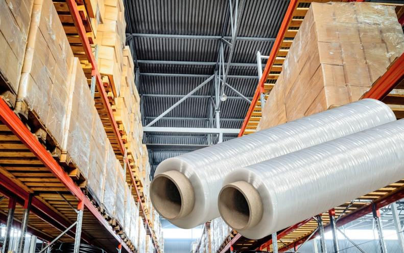 Rolls of pre-stretched film wait to be used in a warehouse
