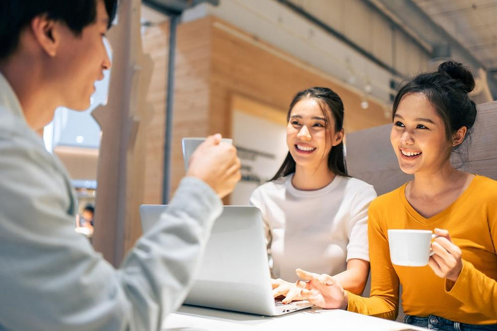 Co-workers enjoying a cup of coffee while working 
