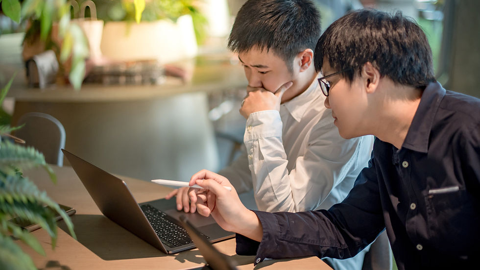 Professionals reviewing work together at a flexible coworking space in Sathorn