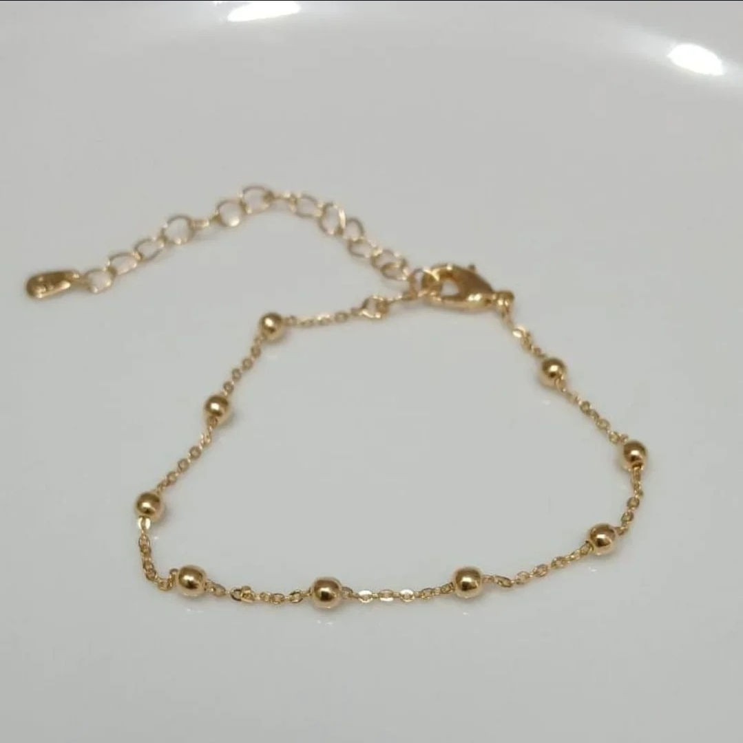 Pulseira esfera lisa. Banho ouro 