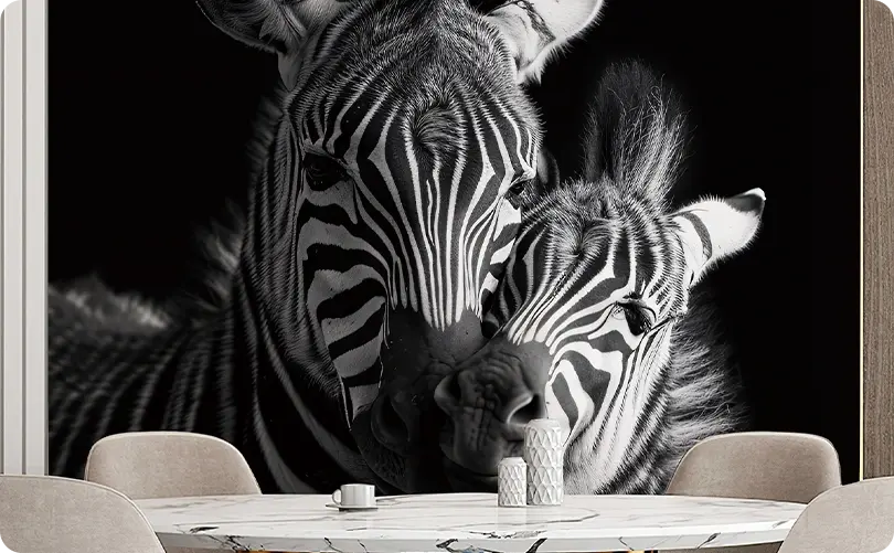 Zebra mural with two zebras nuzzling. Black and white pattern. Marble table with simple decor in foreground. Cozy and intimate atmosphere.