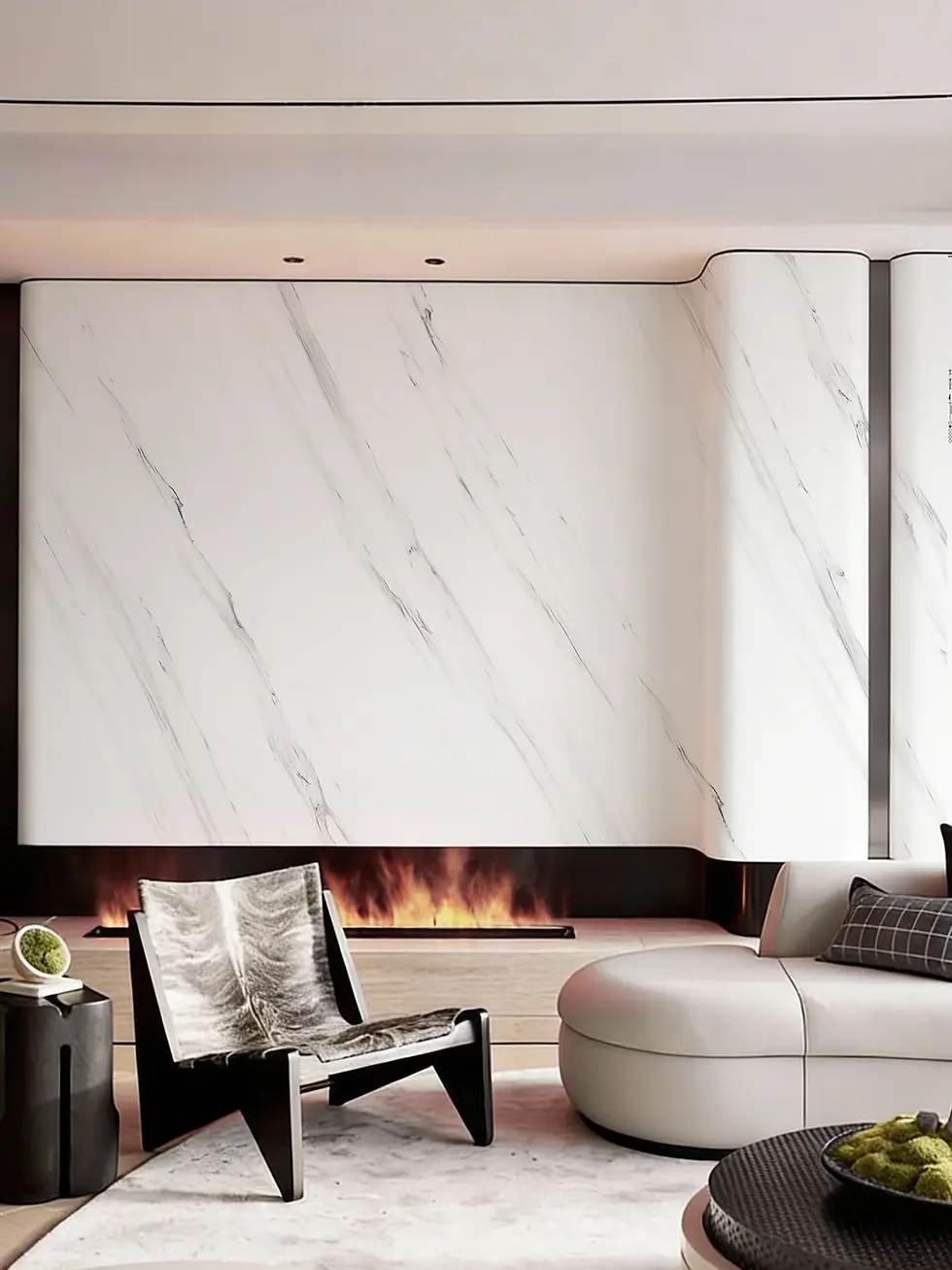 Modern living room with a black chair, round white sofa, and round table with green decor. Marble wall and electric fireplace. Cozy ambiance.