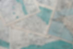 A photograph of turquoise and white coastal maps.