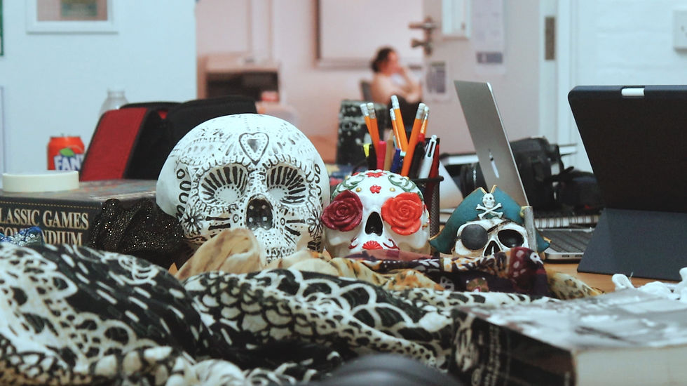A still life setup of skulls, books and fabric