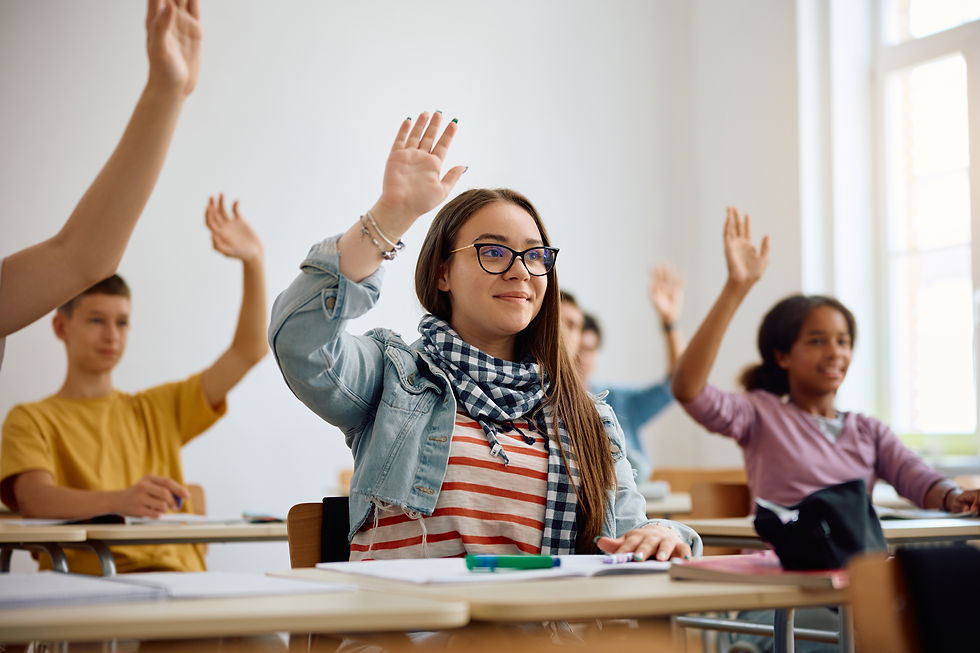 High school student and classmates raising hands