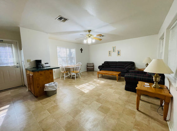 Living room featuring several couches, tables, etc.