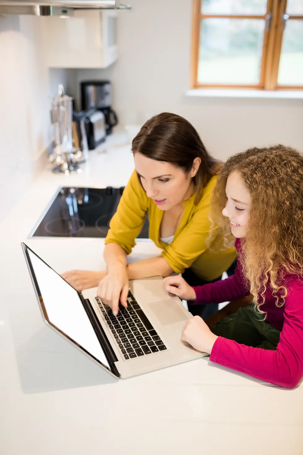 mother-daughter-using-laptop (1).webp