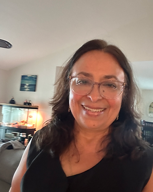 A picture of the CEO of the company, Maria Phipard, wearing a black top and brown hear and eye glasses