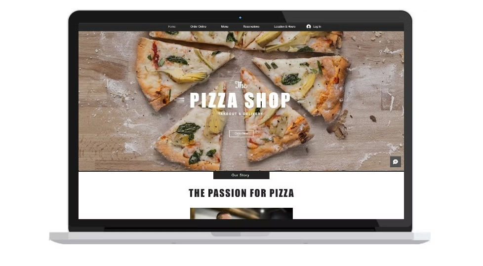Laptop displaying a pizza shop website, featuring sliced pizza with toppings. Text reads "The Pizza Shop" with a rustic wood background.