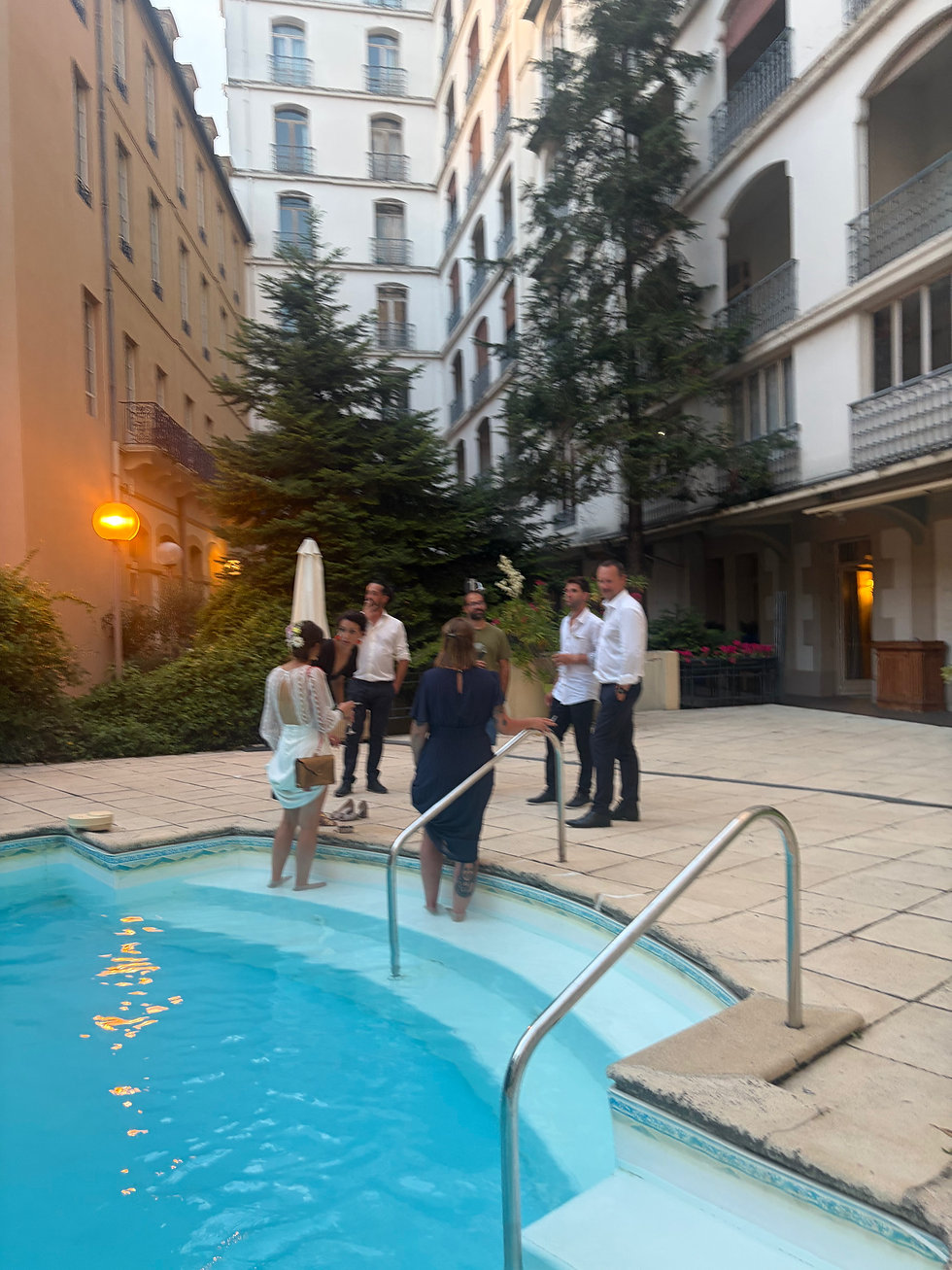 Hotel wedding guests wading in the pool to cool off during the hottest day of the year.