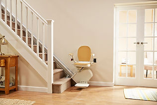Modern stairlift installed on a carpeted staircase in a neutral home interior.