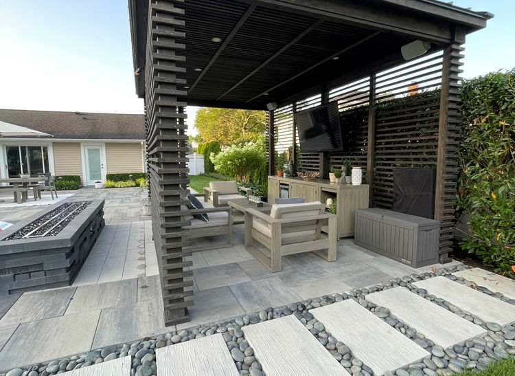 Modern outdoor patio structure with seating and stone pathway